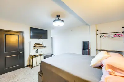 a bedroom with a large bed and a tv at 3 Mi to Dtwn Cleveland Condo with Lake Erie Views! in Cleveland