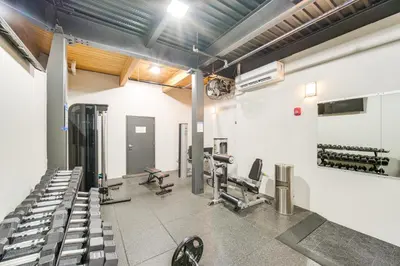 a gym with chairs and machines in a room at 3 Mi to Dtwn Cleveland Condo with Lake Erie Views! in Cleveland
