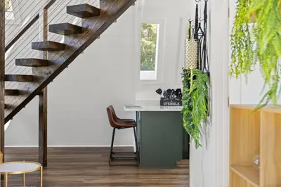 a kitchen with a desk and a staircase in a house at Hot-Tub Sauna Cold Plunge - Evergreen Escape in Campton