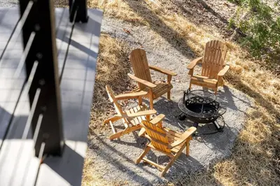 an overhead view of two rocking chairs and a fire pit at Hot-Tub Sauna Cold Plunge - Evergreen Escape in Campton