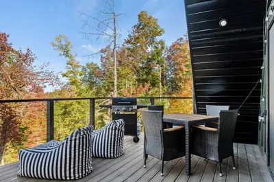 a deck with a table and chairs and a grill at Hot-Tub Sauna Cold Plunge - Evergreen Escape in Campton