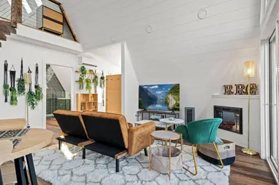 a living room with a couch and a fireplace at Hot-Tub Sauna Cold Plunge - Evergreen Escape in Campton