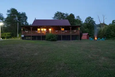 a large house with a large yard in front of it at Hot Tub WiFi Firepit HazelBrook Haven in Hazel Green