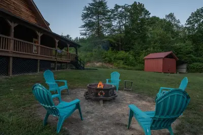 a group of chairs around a fire pit in a yard at Hot Tub WiFi Firepit HazelBrook Haven in Hazel Green