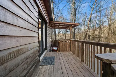 a porch of a wooden house with a bench on it at Hot Tub No Pet Fee Prime Location - Beary Cozy in Slade