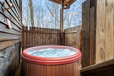 a large hot tub in a wooden fence at Hot Tub No Pet Fee Prime Location - Beary Cozy in Slade