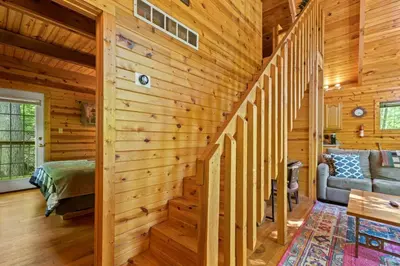 a log cabin with a staircase in a living room at Hot Tub No Pet Fee - Beary Secluded - RRG in Slade