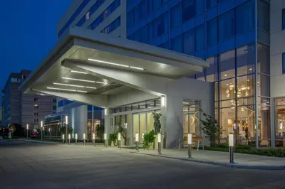 an office building with a lit up facade at night at Holiday Inn Cleveland Clinic by IHG in Cleveland