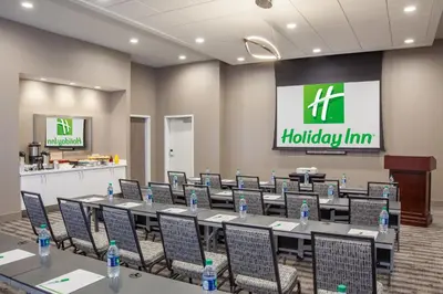 a conference room with tables and chairs with water bottles at Holiday Inn Cleveland Clinic by IHG in Cleveland