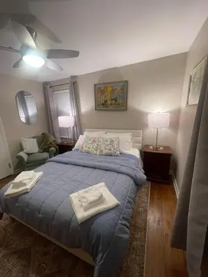 a bedroom with a bed with towels on it at Newly renovated 3-bedroom lakeside home in Euclid