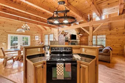 a kitchen and living room with a stove in a cabin at Pool Table WiFi Starry Mountain Night RRG in Stanton