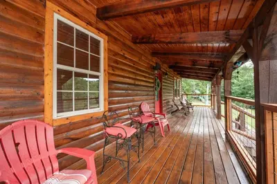 a porch of a cabin with red chairs and tables at Pool Table WiFi Starry Mountain Night RRG in Stanton