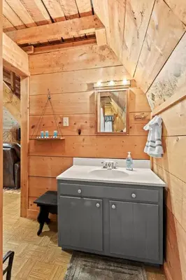 a bathroom with a sink and a mirror at Sugar Shack - Cave Run Lake OR Red River Gorge KY in Bangor