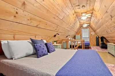 a bed in a room with a wooden ceiling at Sugar Shack - Cave Run Lake OR Red River Gorge KY in Bangor