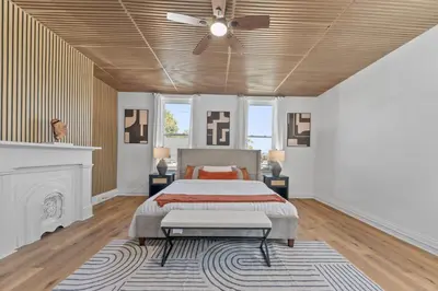 a bedroom with a bed and a ceiling fan at Watkins Complex in Covington