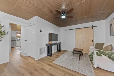 a living room with a ceiling fan and a couch at Watkins Complex in Covington
