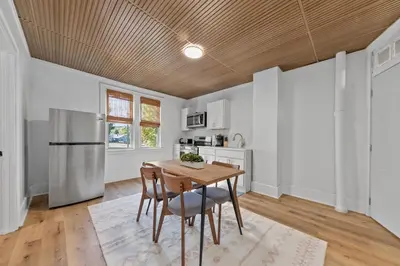 a kitchen with a wooden ceiling and a table and chairs at Watkins Complex in Covington