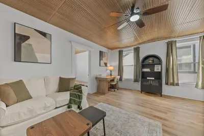 a living room with a couch and a ceiling fan at Watkins Complex in Covington
