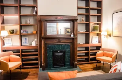 a living room with a fireplace and shelves at Classic Hilltop 3br home on Eastern ready for you! in Cincinnati