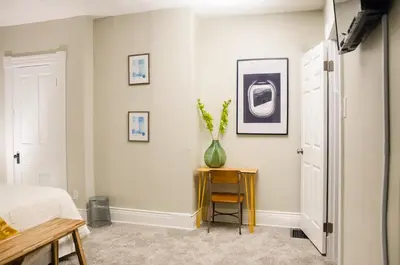 a bedroom with a bed and a vase on a table at Classic Hilltop 3br home on Eastern ready for you! in Cincinnati
