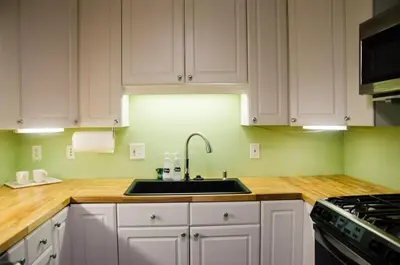 a kitchen with white cabinets and a sink at Classic Hilltop 3br home on Eastern ready for you! in Cincinnati