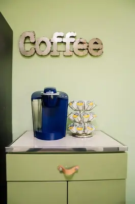 a cabinet with a coffee sign on the wall at Classic Hilltop 3br home on Eastern ready for you! in Cincinnati