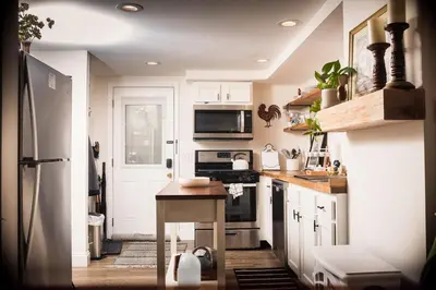 a kitchen with a refrigerator and a stove top oven at Country cottage in Cheviot! in Cincinnati