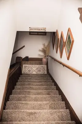 a staircase in a house with a stair case at Country cottage in Cheviot! in Cincinnati
