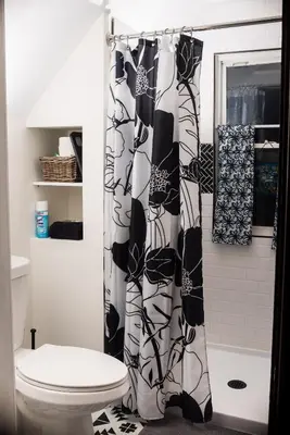 a bathroom with a toilet and a shower curtain at Country cottage in Cheviot! in Cincinnati