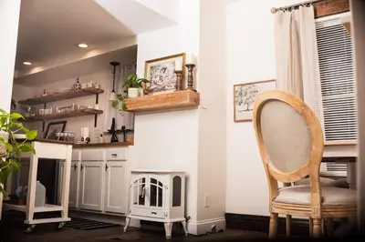a living room with a chair and a fireplace at Country cottage in Cheviot! in Cincinnati