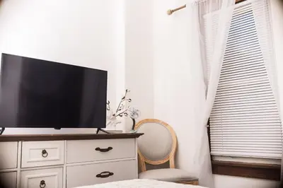 a tv on top of a dresser in a bedroom at Country cottage in Cheviot! in Cincinnati