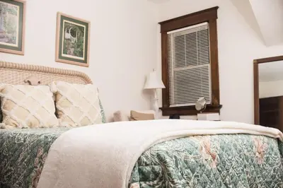 a bedroom with a large bed and a window at Country cottage in Cheviot! in Cincinnati