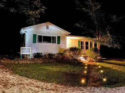 a house with a sign in front of it at night at WiFi & Pets - Alice Rocks - Cave Run Lake & RRG KY in Frenchburg