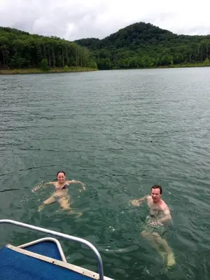 two men swimming in the water on a boat at WiFi & Pets - Alice Rocks - Cave Run Lake & RRG KY in Frenchburg
