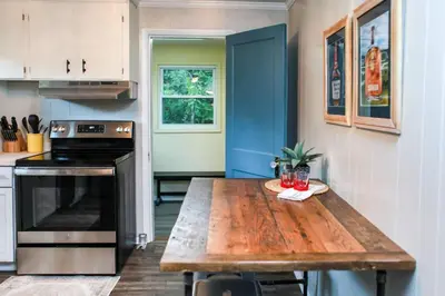 a kitchen with a wooden table in a kitchen at WiFi & Pets - Alice Rocks - Cave Run Lake & RRG KY in Frenchburg