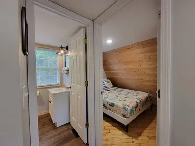 a small bedroom with a bed and a bathroom at A Frame of Mind - near Red River Gorge KY in Jeffersonville
