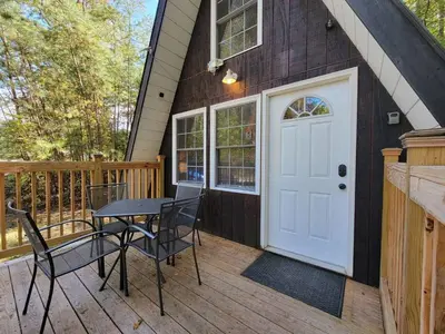 a house with a table and chairs on a deck at A Frame of Mind - near Red River Gorge KY in Jeffersonville