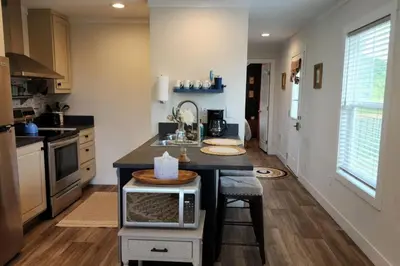 a kitchen with a island in the middle of a room at WiFi Firepit Fishing Pond - FarmView in Hazel Green