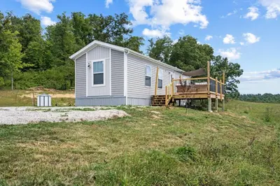 a tiny house on a hill in a field at WiFi Firepit Fishing Pond - FarmView in Hazel Green