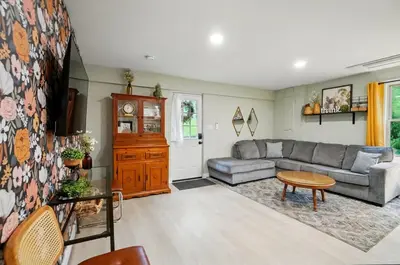a living room with a couch and a table at Carriage House Retreat 1 in Milford