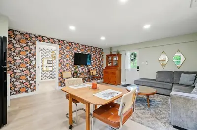 a living room with a table and a couch at Carriage House Retreat 1 in Milford