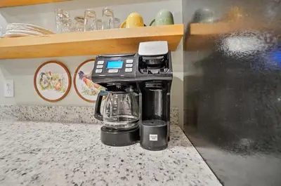 a coffee maker sitting on top of a counter at Carriage House Retreat 1 in Milford
