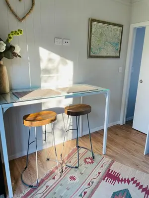 a desk with two stools in a room at The Travellers Tiny Hideaway in Cincinnati