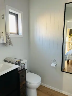 a bathroom with a toilet and a sink and a mirror at The Travellers Tiny Hideaway in Cincinnati