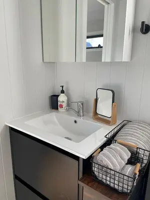 a bathroom with a sink and a mirror and towels at The Travellers Tiny Hideaway in Cincinnati