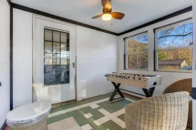 a room with a ping pong table and chairs at Spring Lovers Retreat Sauna, Hot Tub & Firepit in South Bloomingville