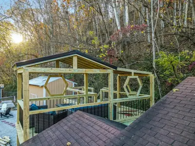 a large wooden gazebo with a playground at Spring Lovers Retreat Sauna, Hot Tub & Firepit in South Bloomingville