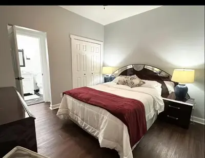 a bedroom with a large bed with a red blanket at Contemporary Private En-Suite - Steps to Cleveland Clinic in Cleveland