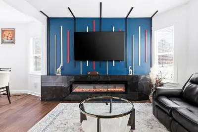 a living room with a fireplace and a tv at Contemporary Private En-Suite - Steps to Cleveland Clinic in Cleveland