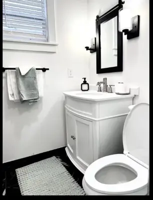 a bathroom with a toilet and a sink and a mirror at Contemporary Private En-Suite - Steps to Cleveland Clinic in Cleveland